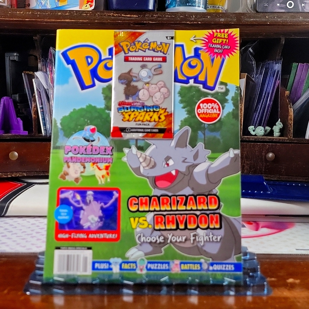 Pokemon magazine with rare surging sparks booster pack